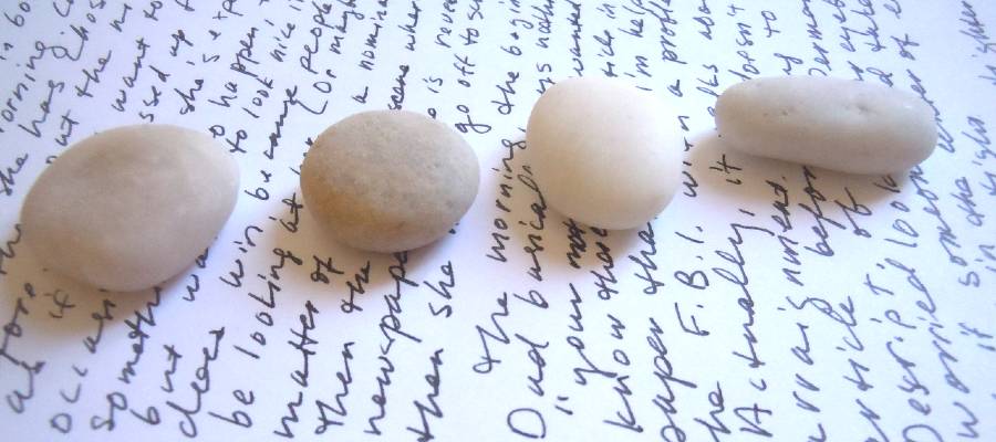 creative writing journal with line of stones on top