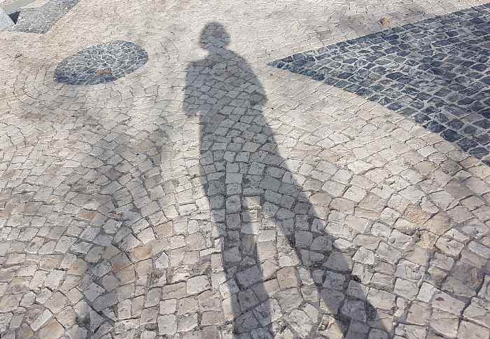 woman's shadow on sidewalk